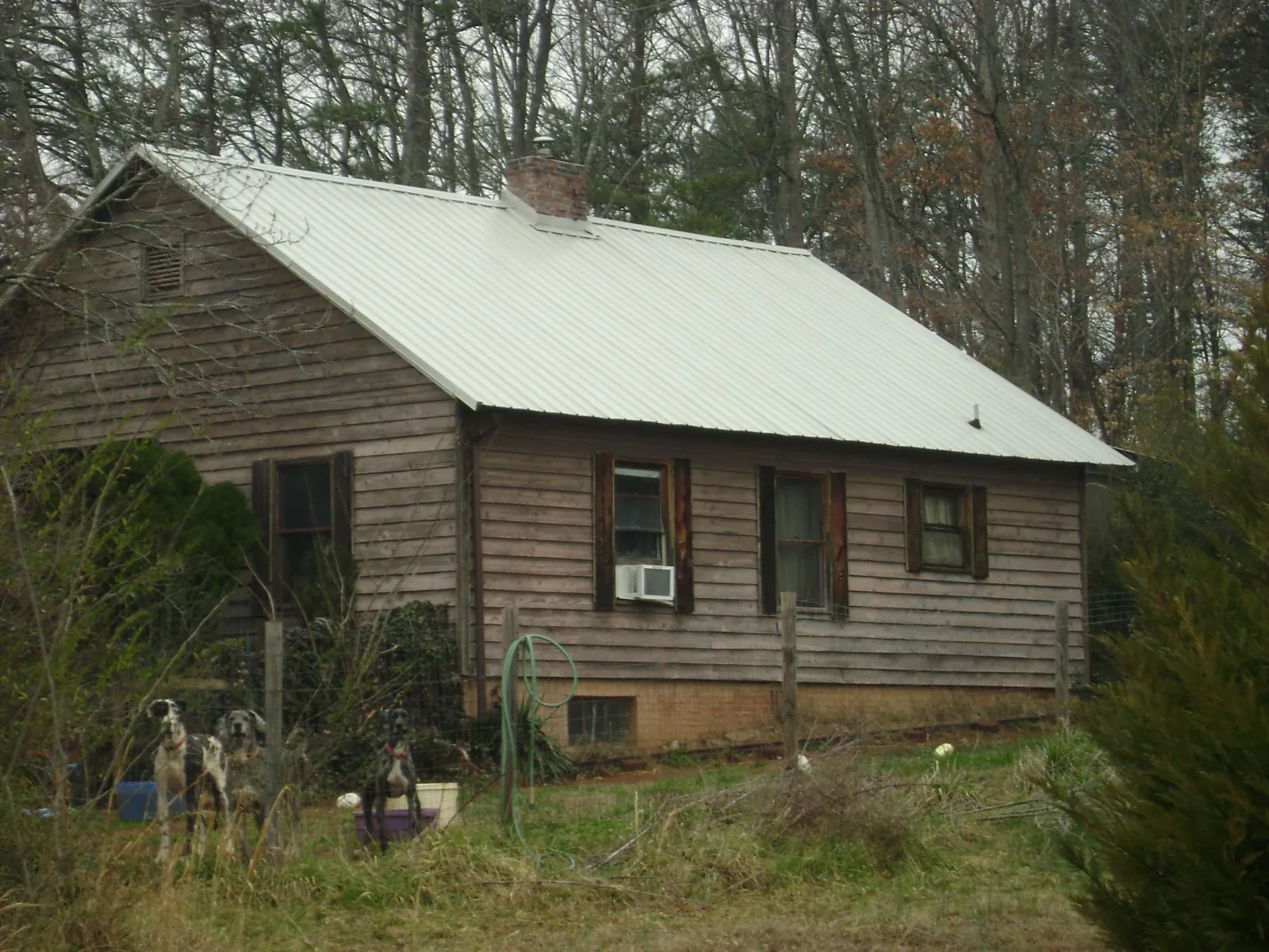 White metal roof on an old wood sided farmhouse, from a Metal Roof Installation job in Green Camp